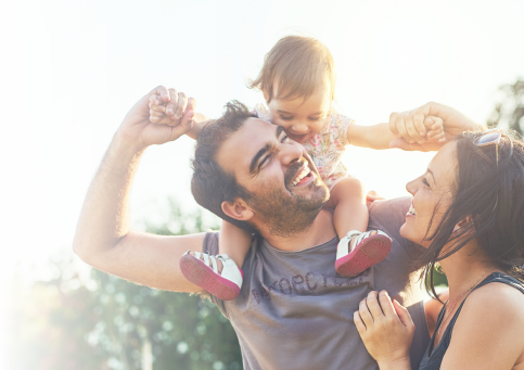 Image of father and mother playing with their daughter